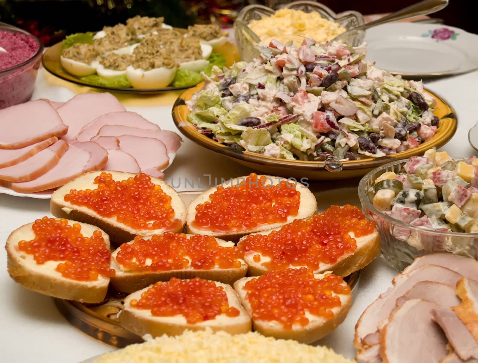 Table covered for a celebratory dinner. Sandwiches with red caviar.