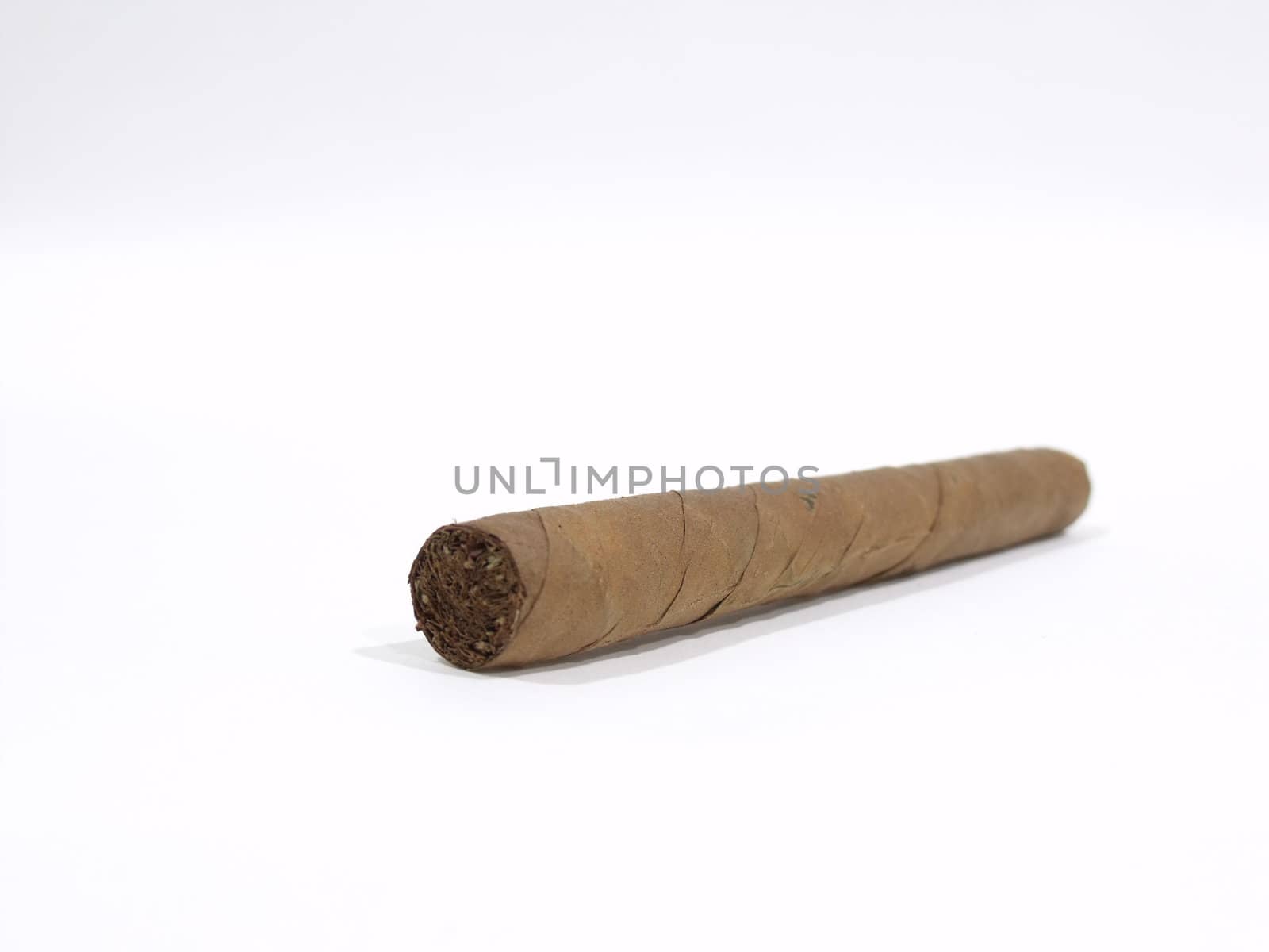 An isolated long wrapped cigar on a white surface