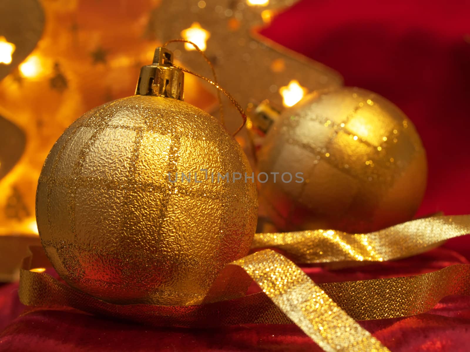 Christmas gold ornaments and gold with lamp like fir on the red background