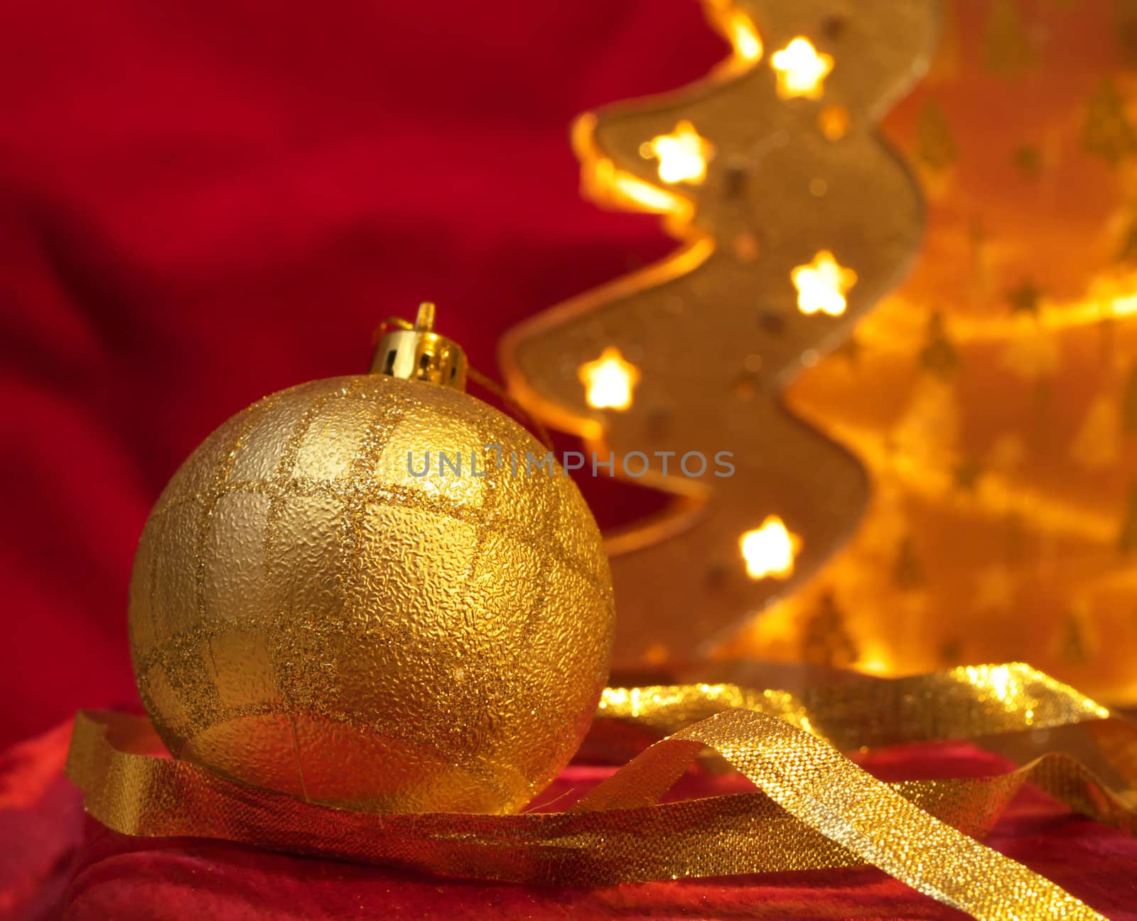 Christmas gold ornaments and gold with lamp like fir on the red background