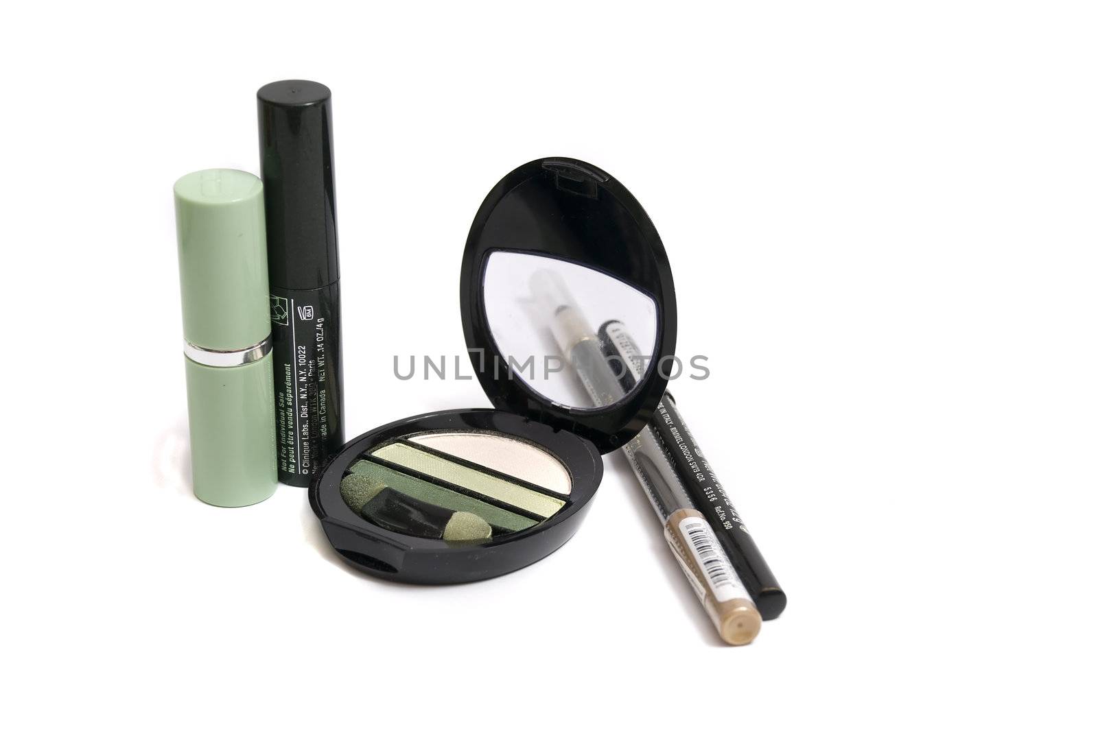 collection of make-up tools on green, isolated on white