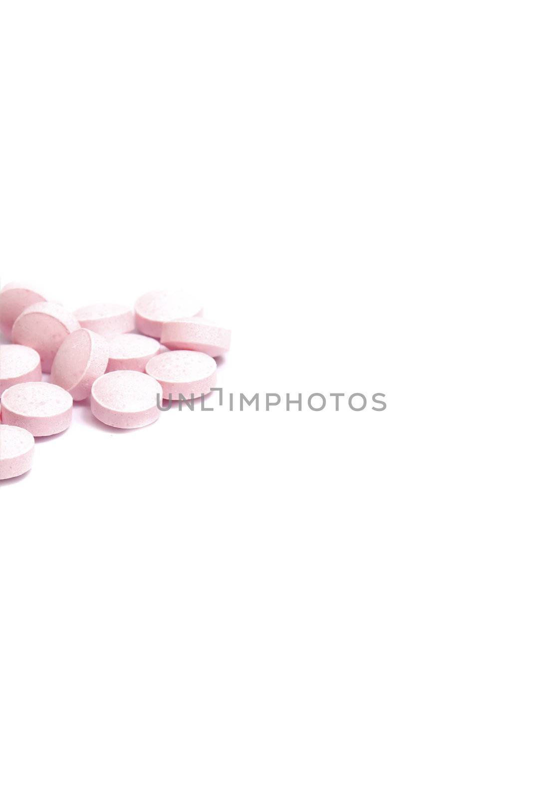 stack of pink pills, isolated on white with space for copy