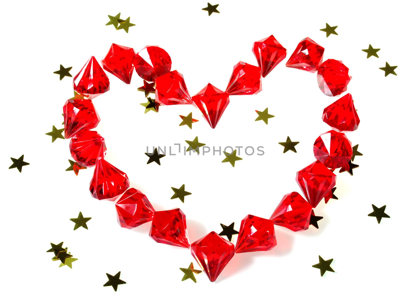 red gems lying in heart shape with gold stars isolated on white perfect for inserting custom message