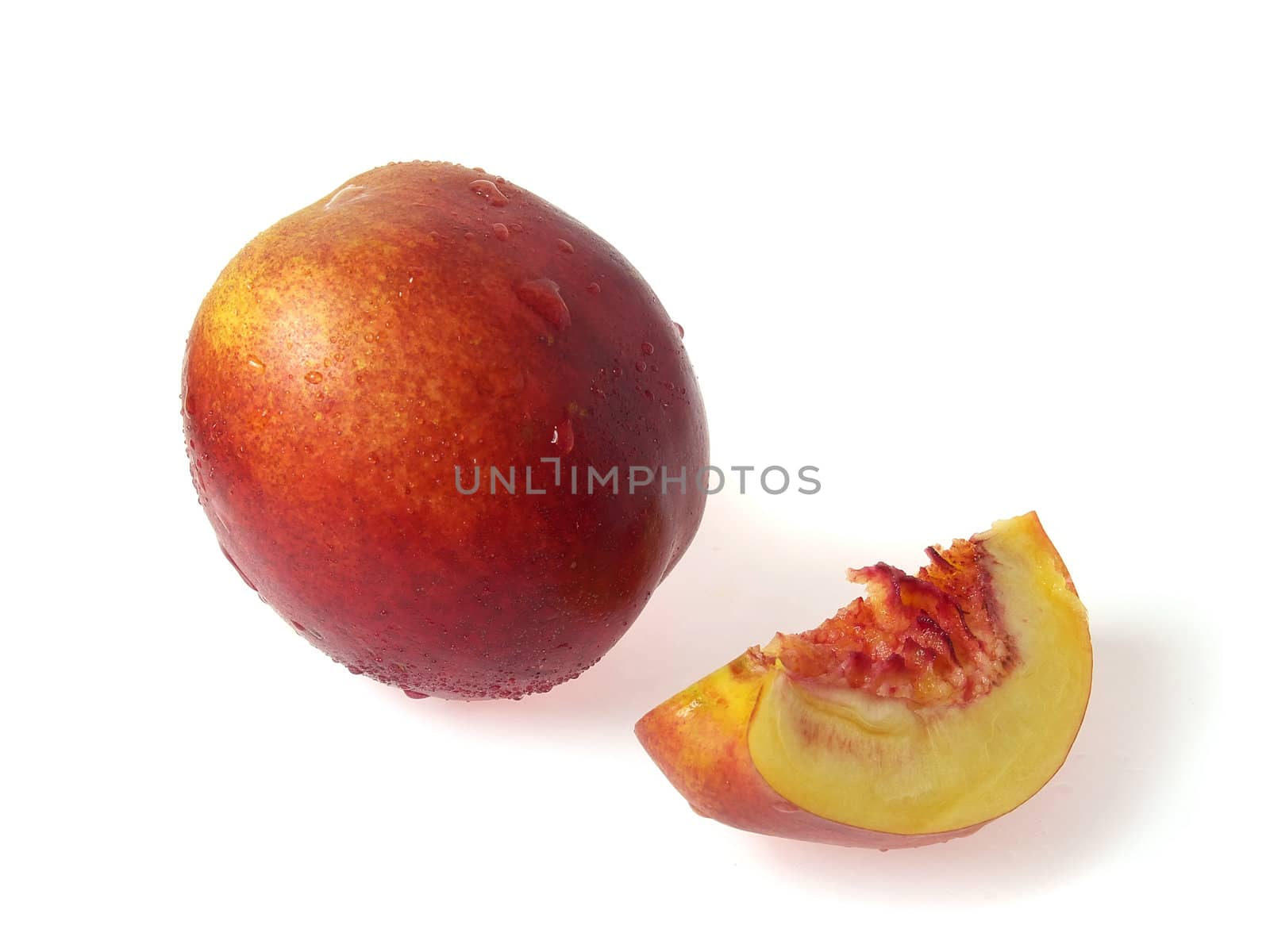 Tasty juicy pieces of nectarine on a white background with water droplets