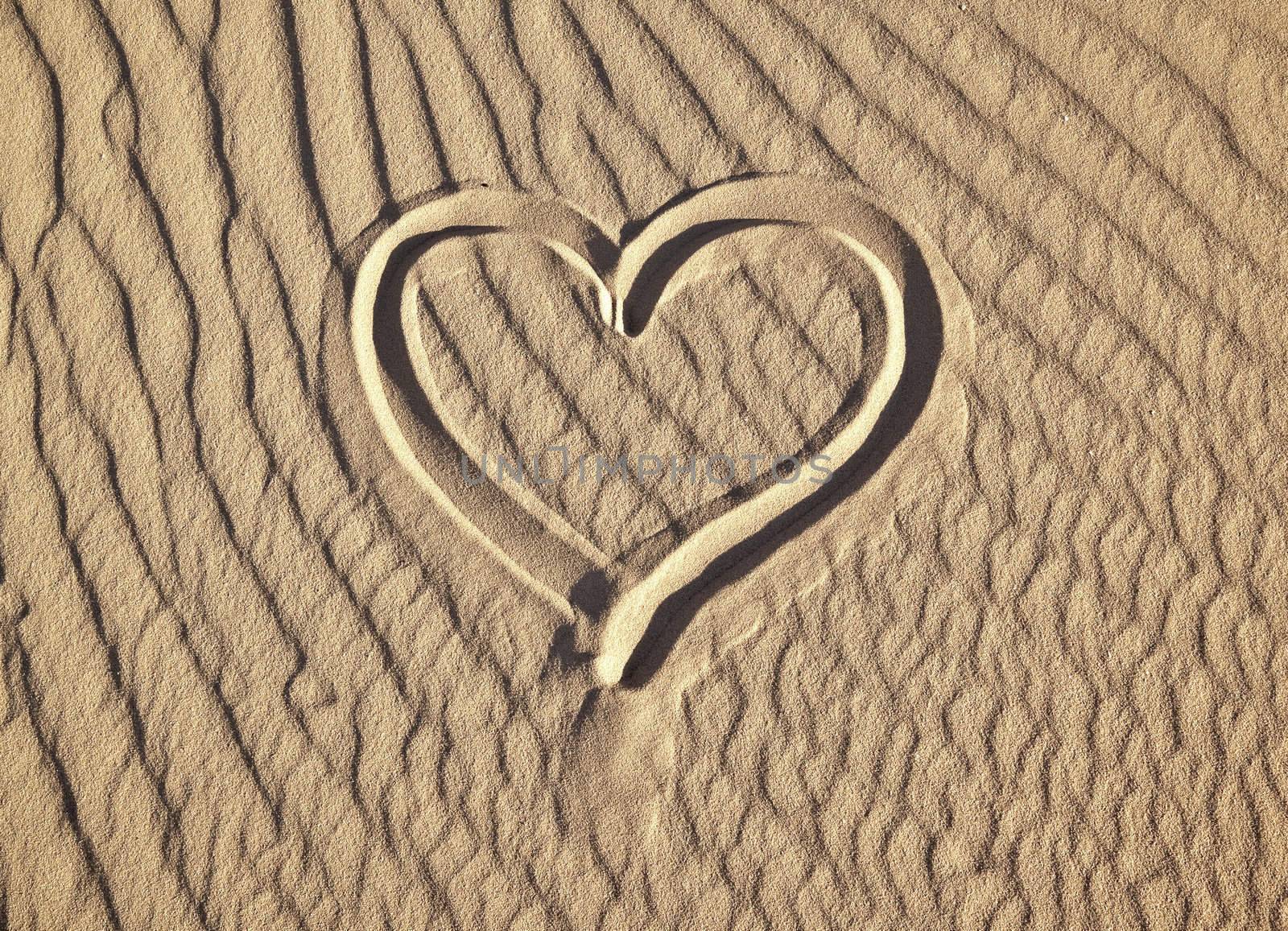 A photography of a heart in the sand
