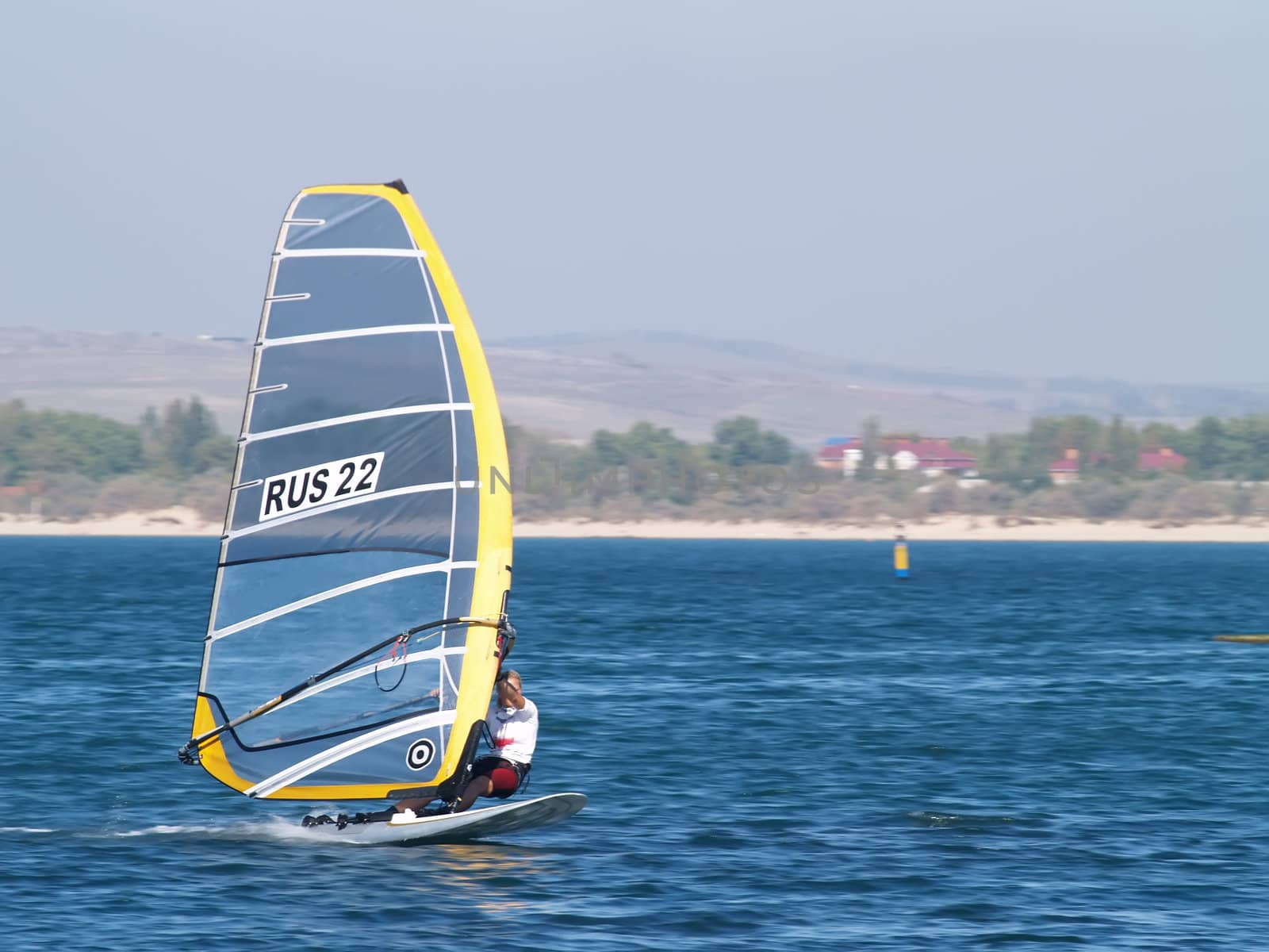 Sailing on calm blue water. Sailboat (yacht) cruising the ocean