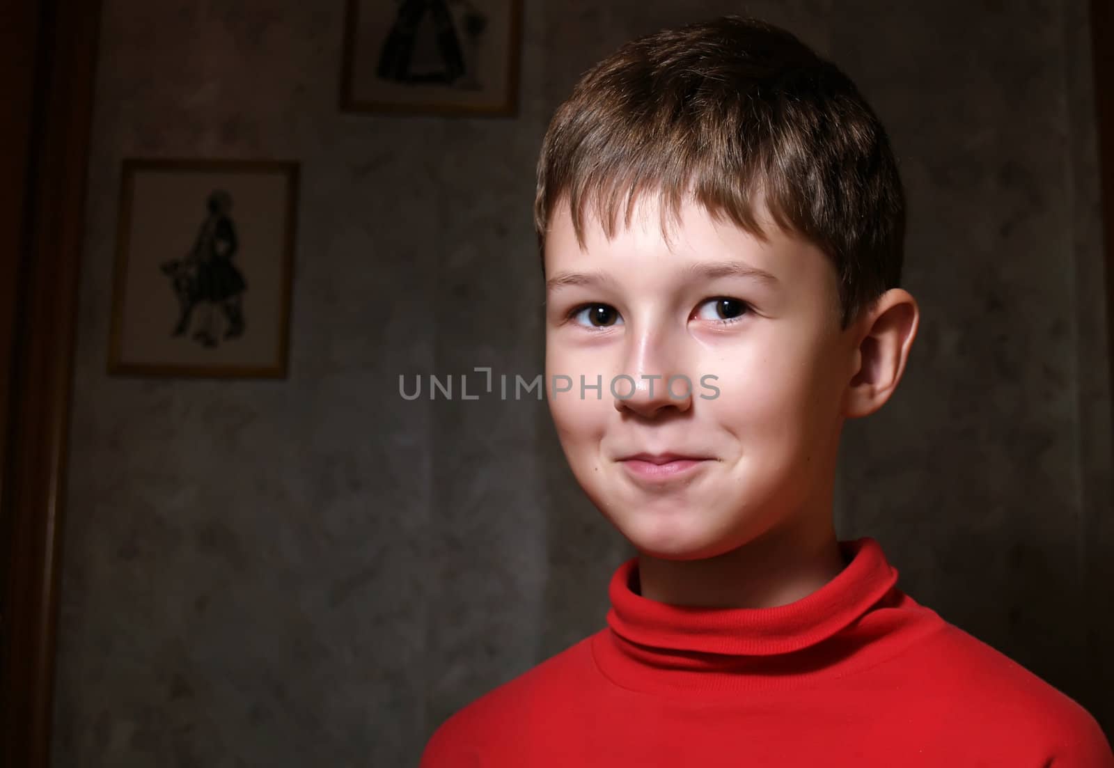 Smiling little boy in dark room