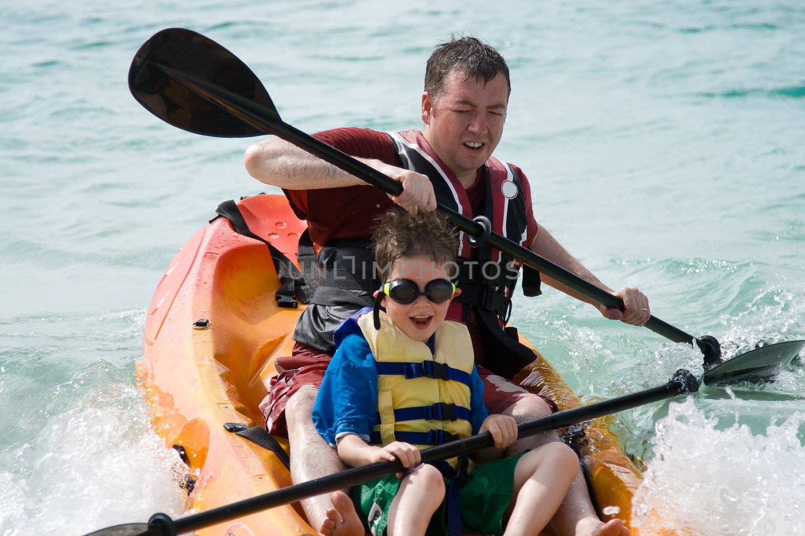 Father and son kayaking by RuthBlack