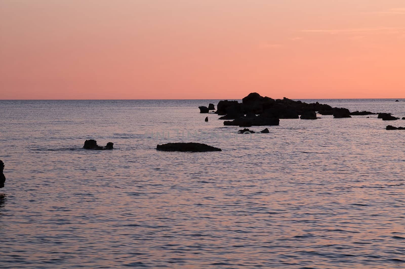 Red sunset with sea and rocks with a lot of copyspace