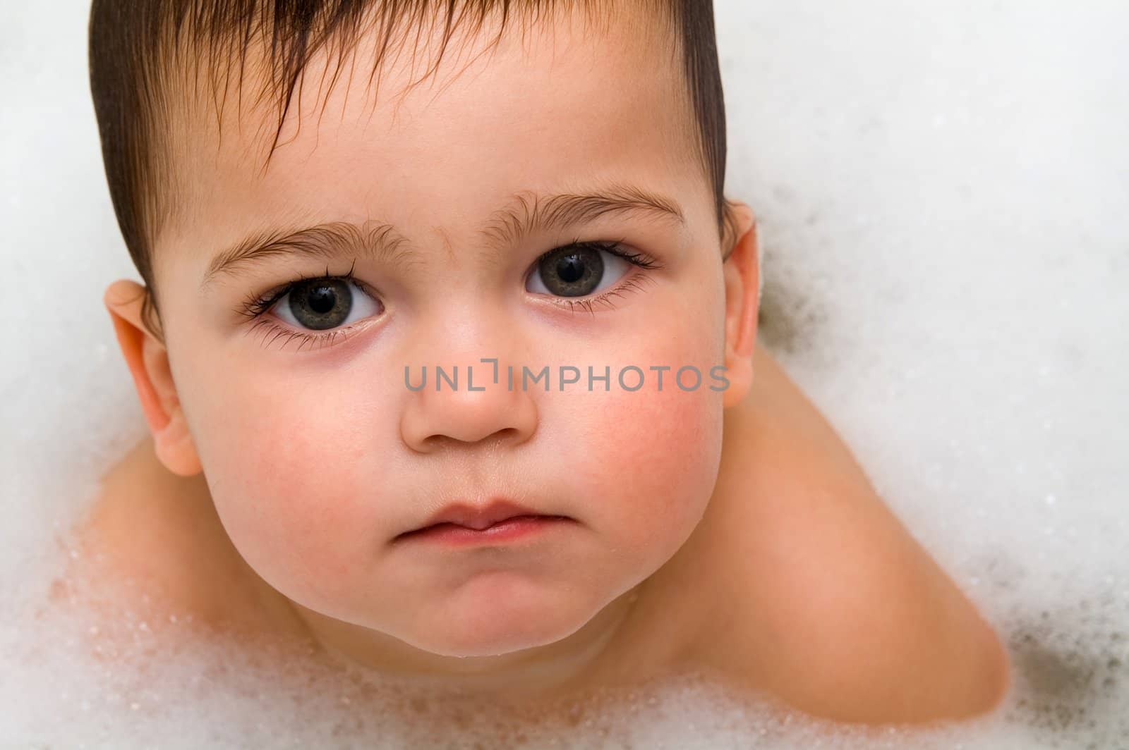 Close-up photo of serious boy in foam