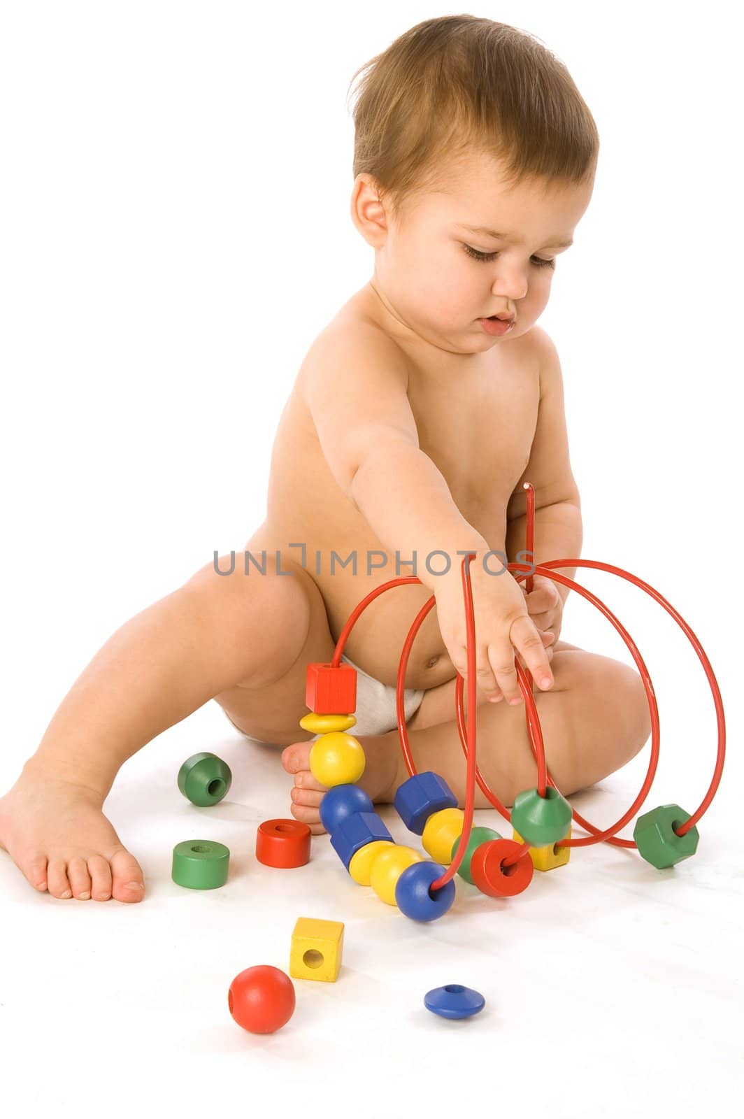 Boy playing with multicolored cubes and curl isolated on white