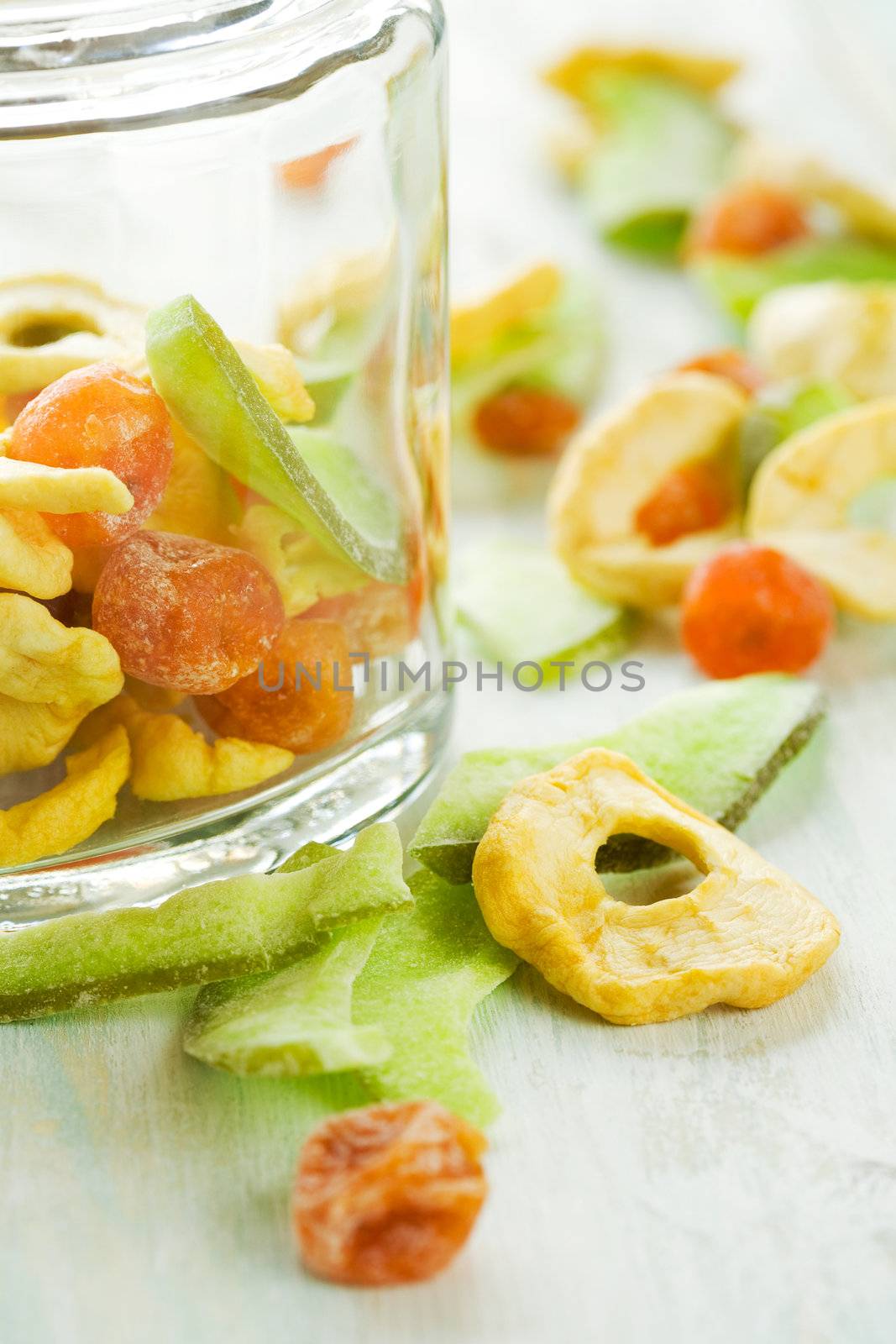 Assortment of sliced dried fruits in jar on table