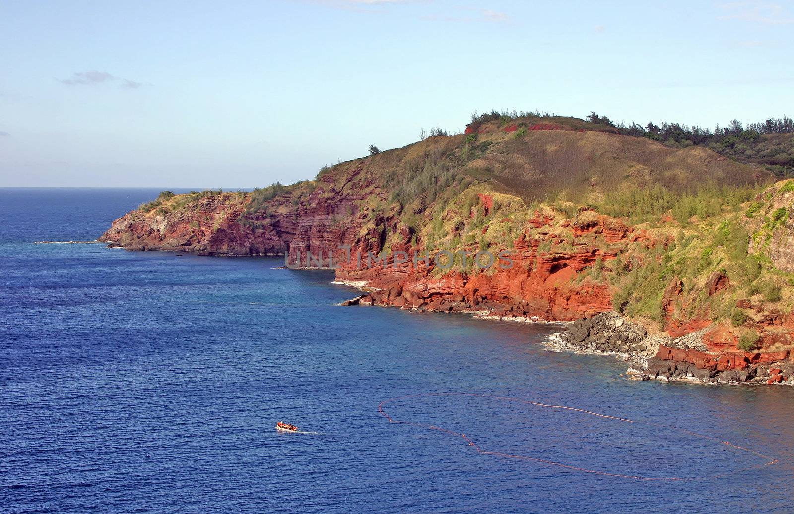 Maui red cliffs and water with a boat