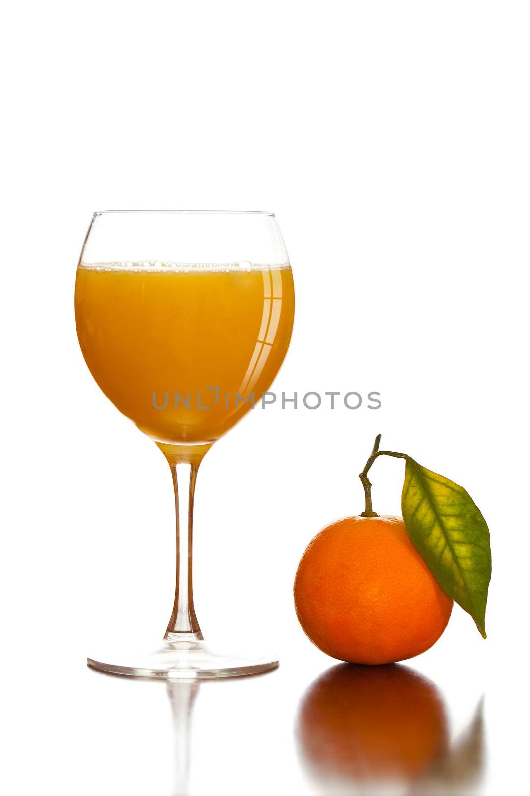 Orange fresh juice in glass and fruit with green leaf
