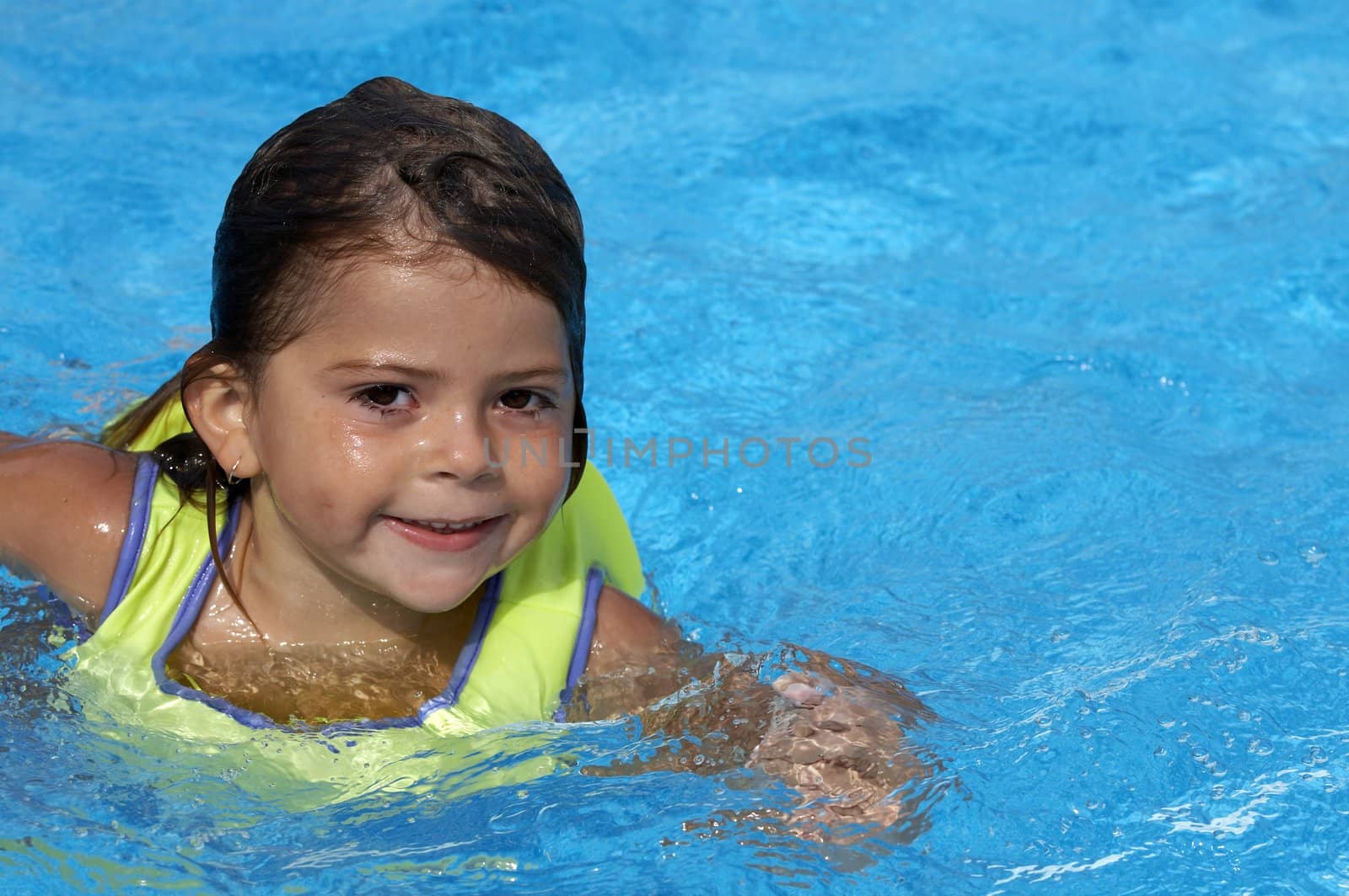 a young girl playing in pool