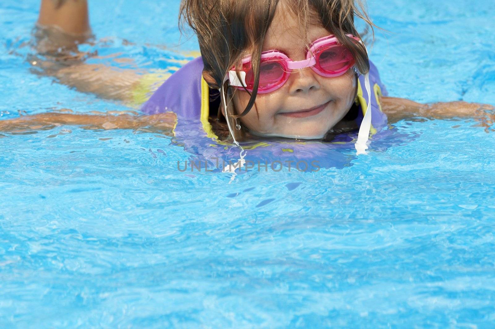 a young girl playing in pool