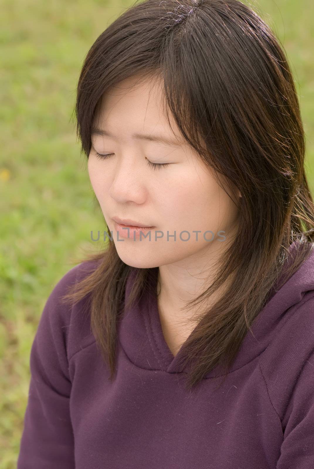 Meditation image of Asian woman sit and closed eyes in outdoor.