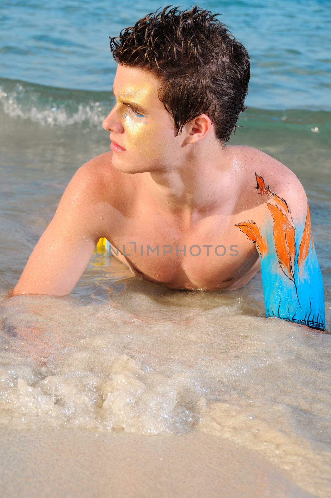 Portrait of beautiful fashion male model enjoying the beach