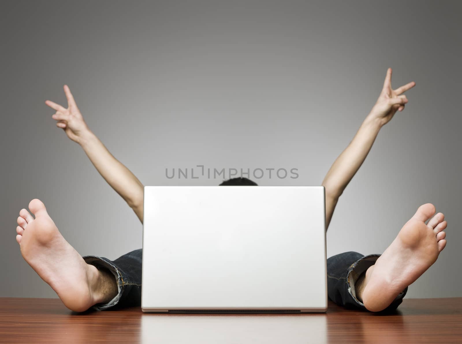 Happy man behing computer in an office