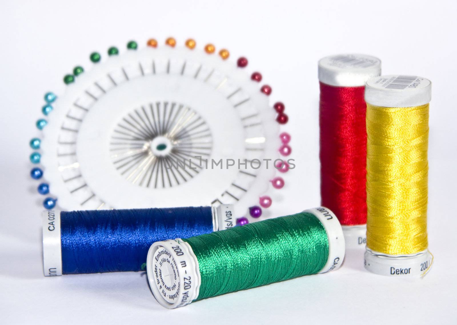 The image of strings for a machine embroidery and pins