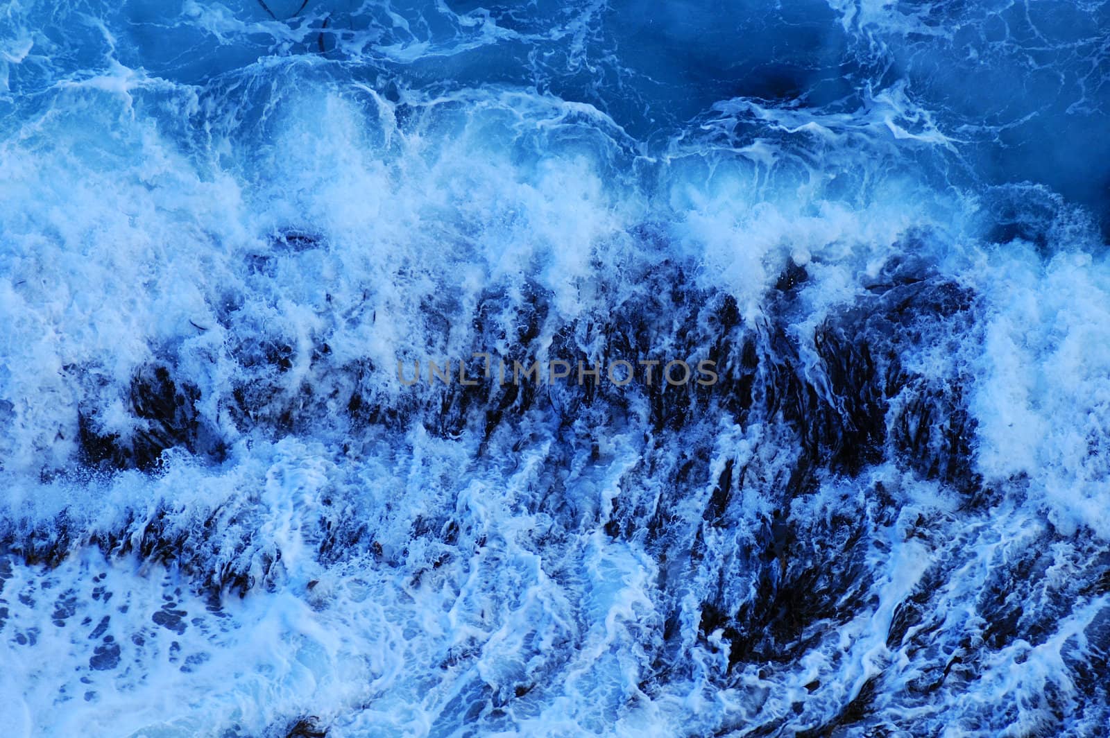 Close up of the foam of a breaking wave, suitable as a graphic background.