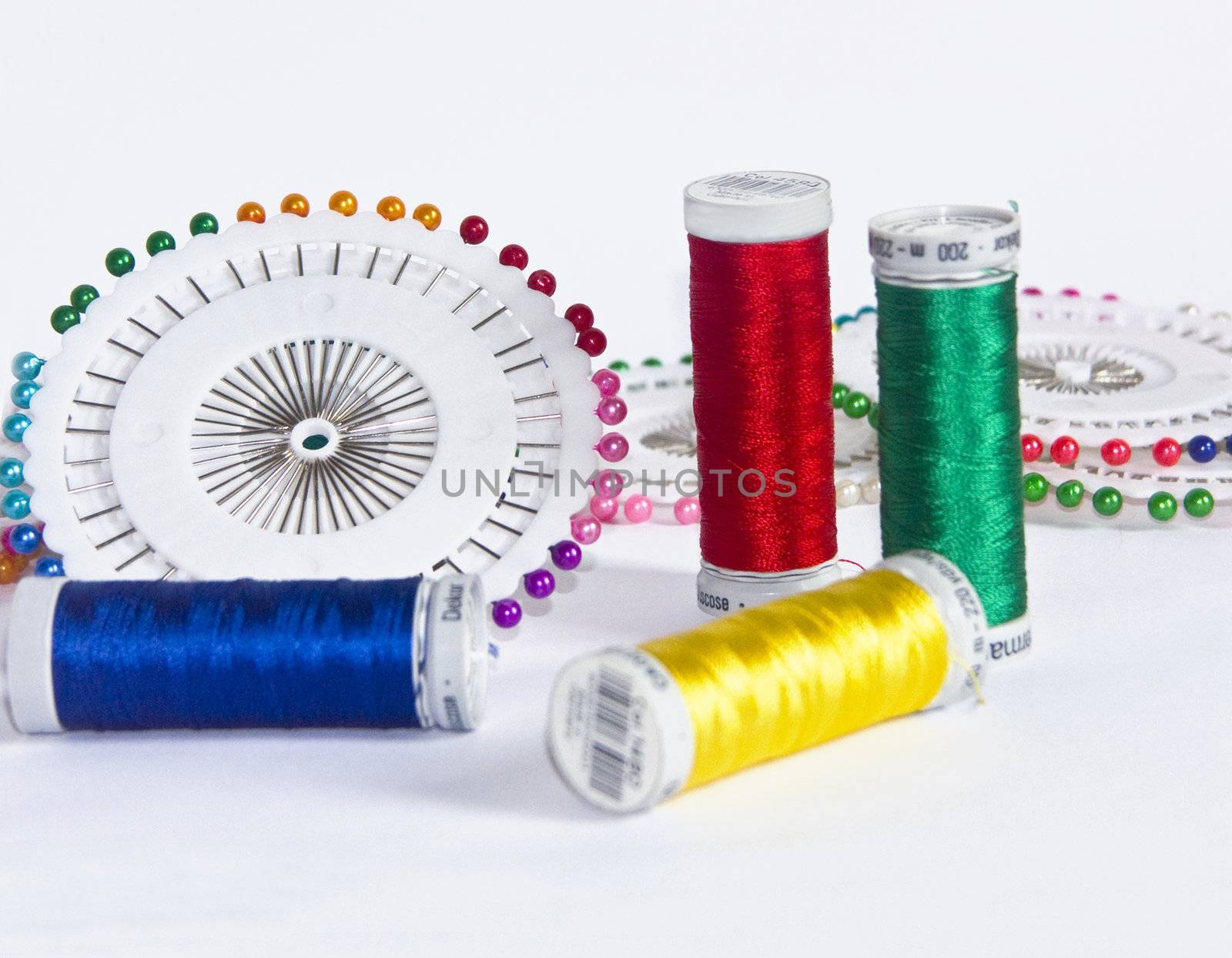 The image of strings for a machine embroidery and pins