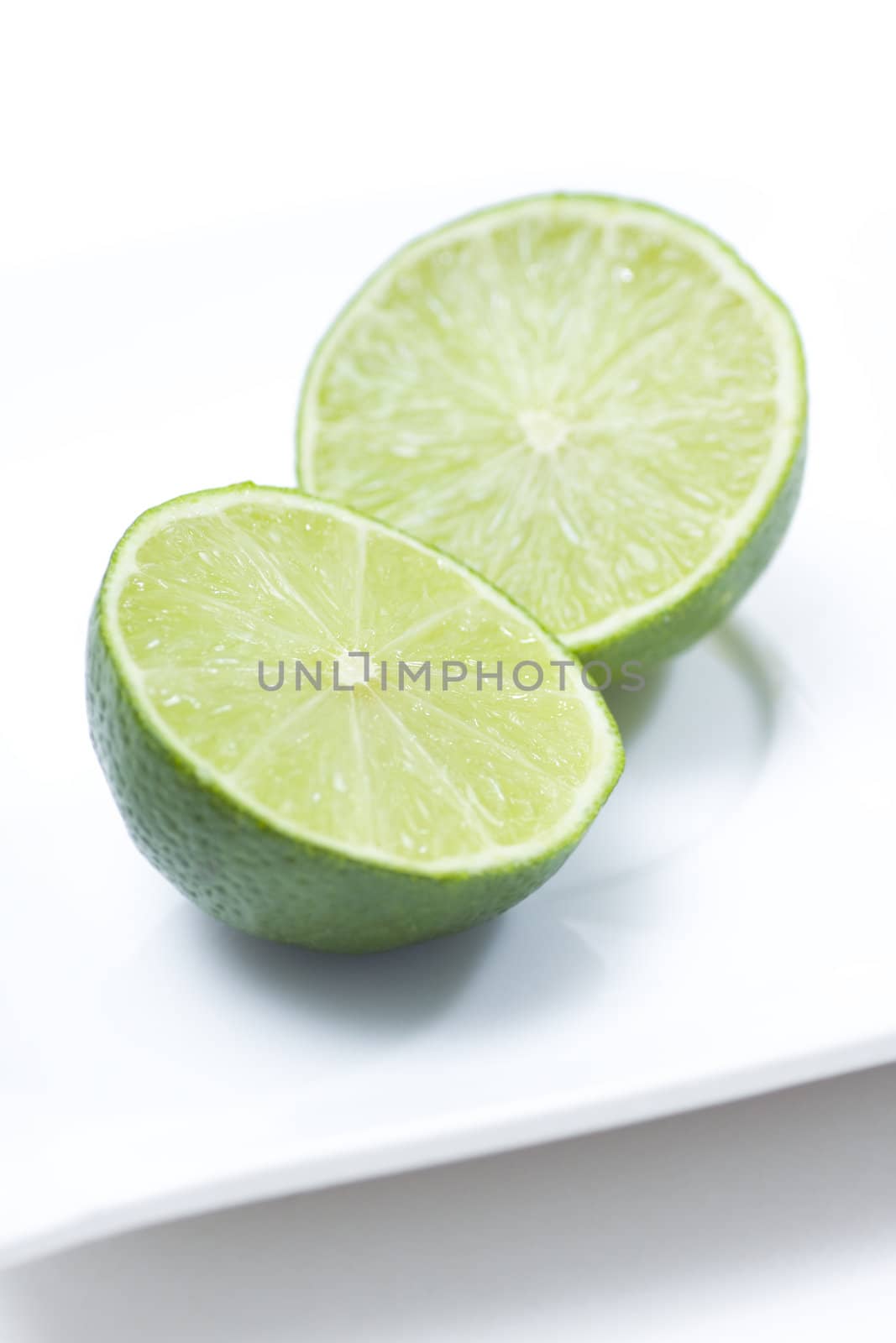 Fresh limes on white plate