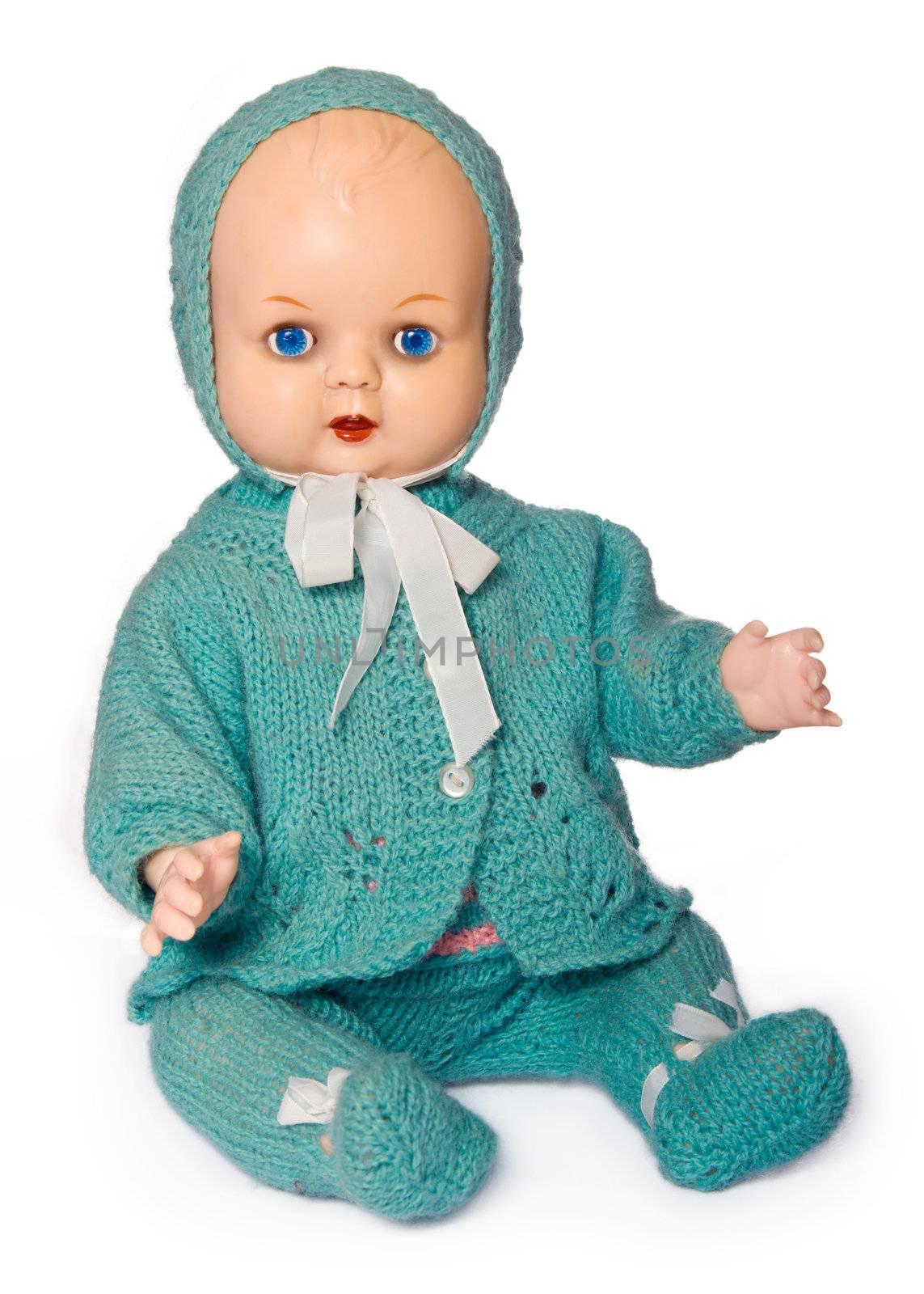Old doll dressed in hand-knitted clothes, isolated against white