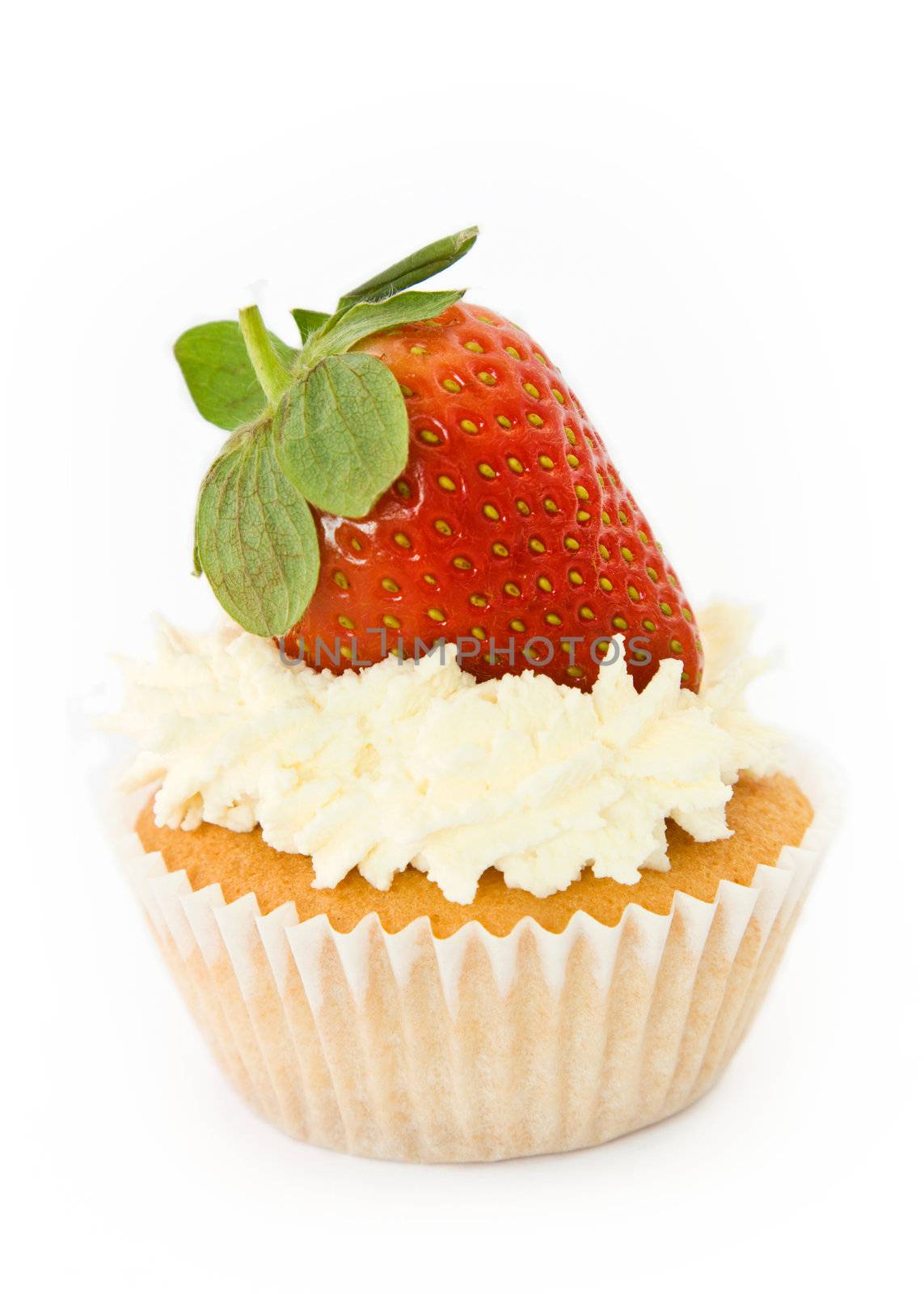 Cupcake decorated with cream and a whole strawberry