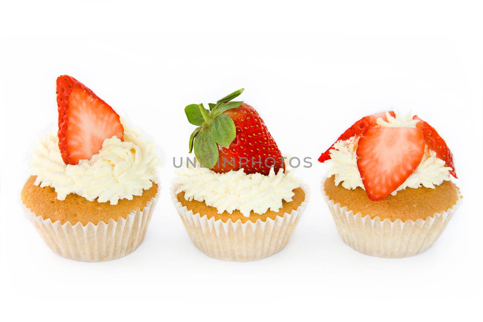 Trio of strawberry cupcakes against white