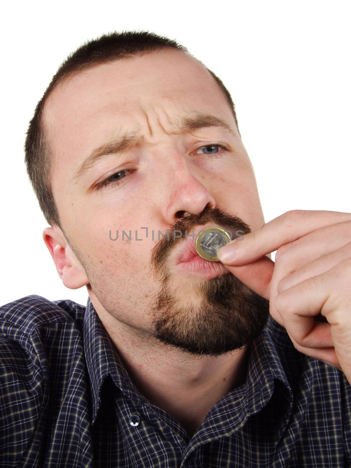 Young Caucasian male portrait. Adult man is kissing a coin, happy of his hard earned money. Savings concept.