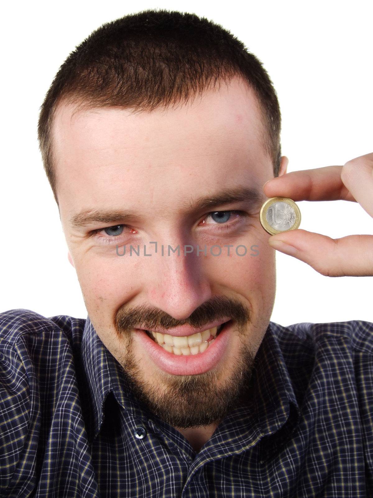 Young adult male happy to have earned some cash. Holding 1 Euro coin in his hand and smiling.