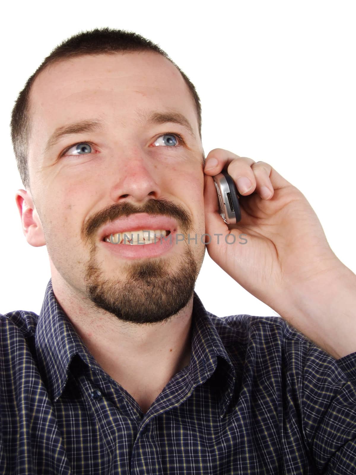 Happy young adult Caucasian man. Holding a mobile phone and talking.