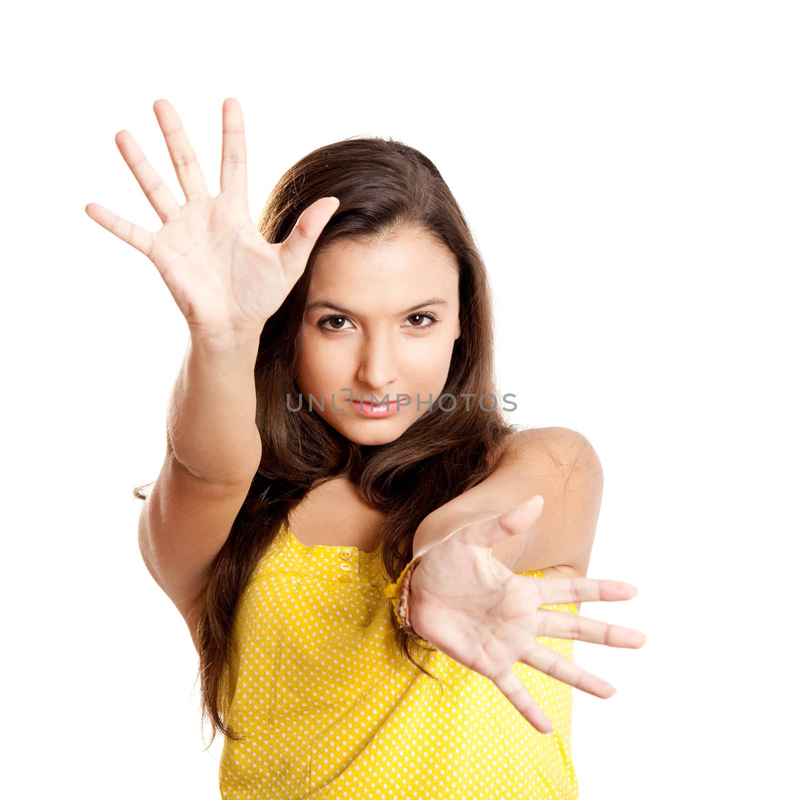 Beautiful young girl with both hands on the air, isolated on white