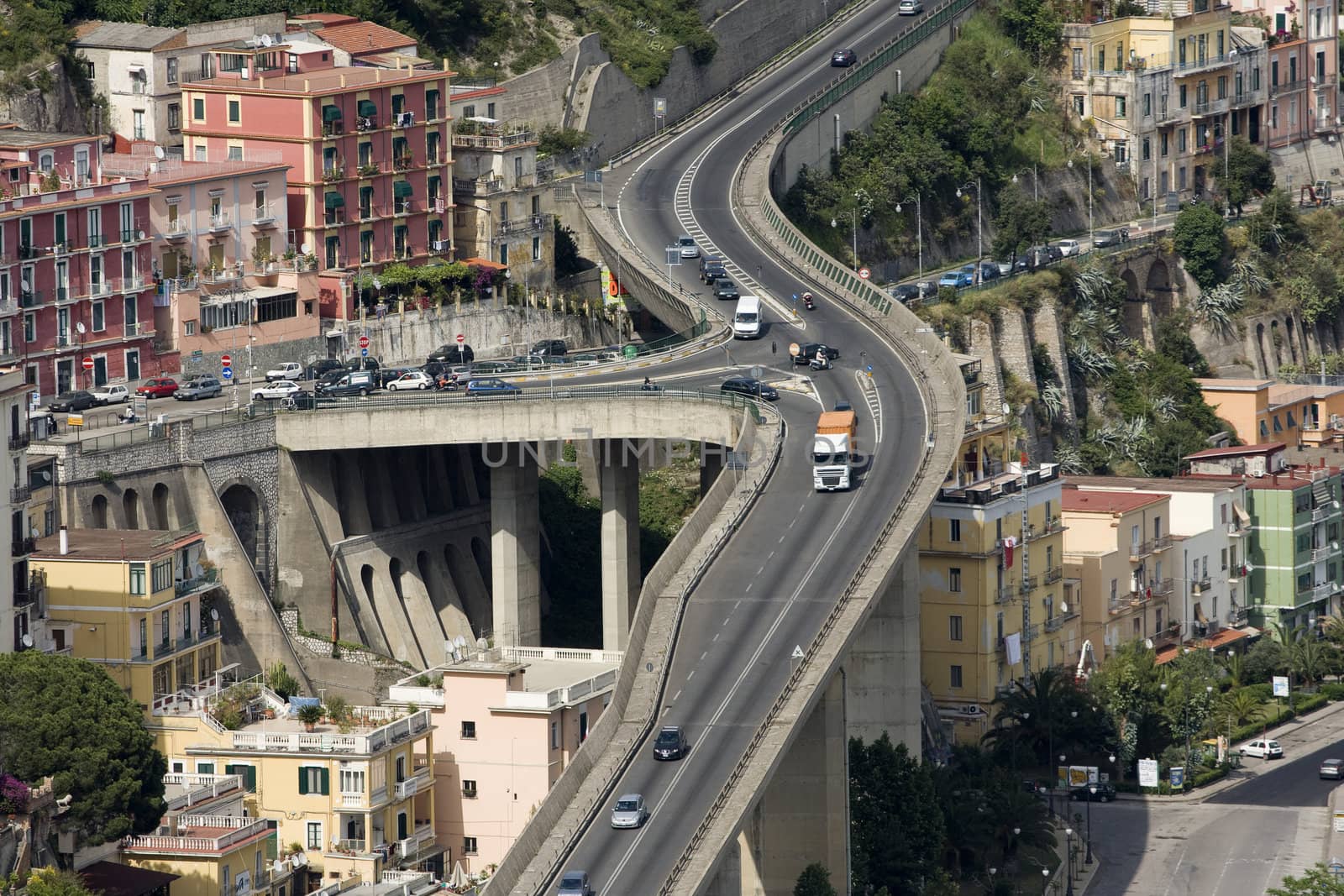 Bird's eye view of multi-level flyover in mountain city somewhere in Italy
