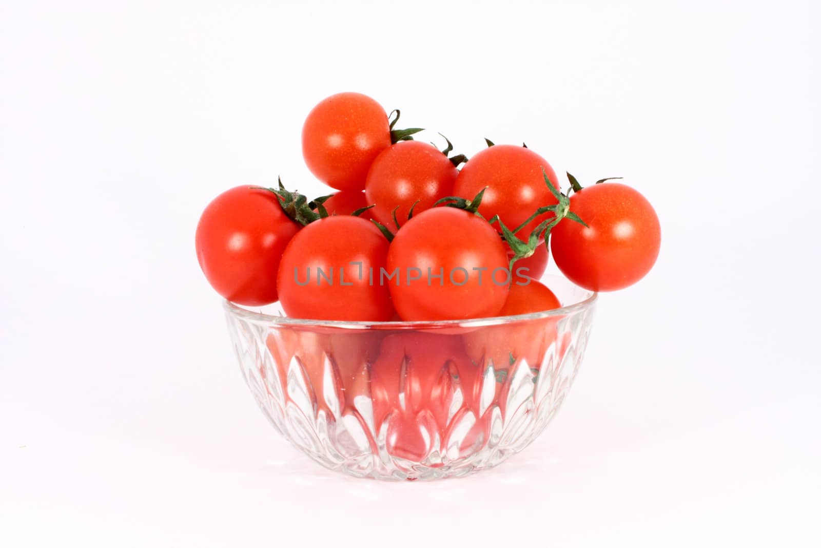 Cherry tomato in glass bowl isolated on white