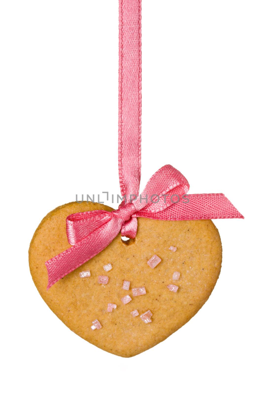 Gingerbread heart tied with a pink ribbon