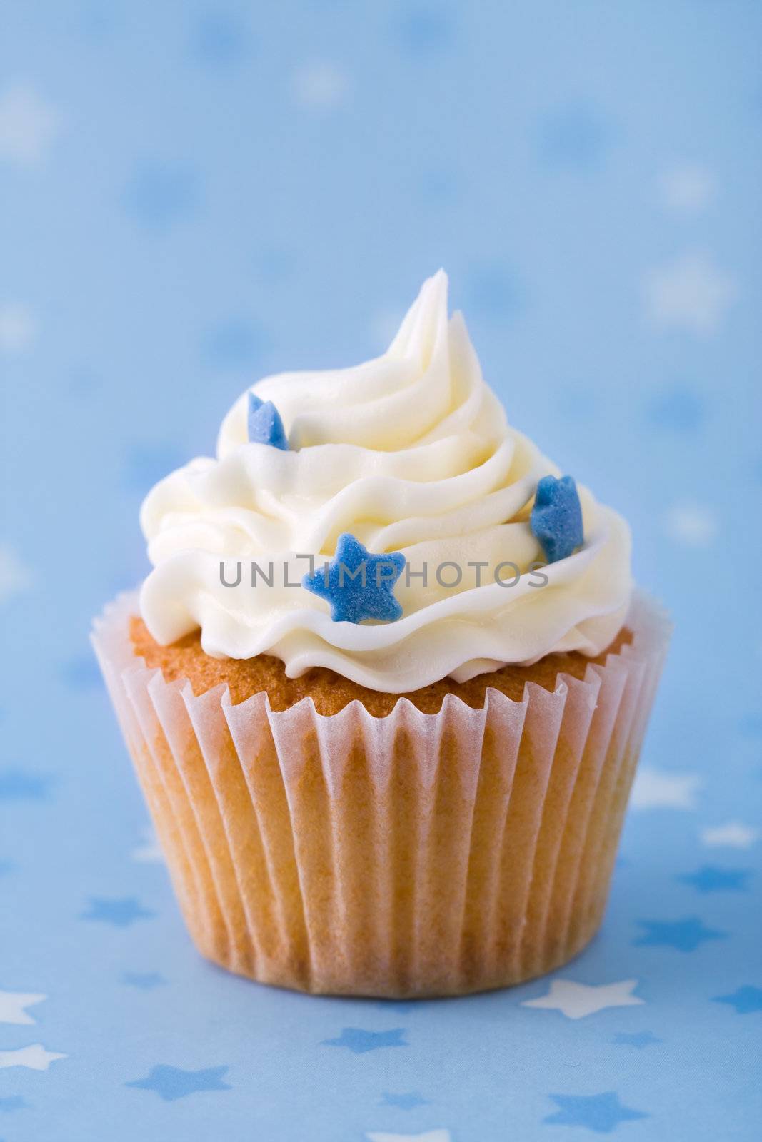 Cupcake decorated with blue sugar stars