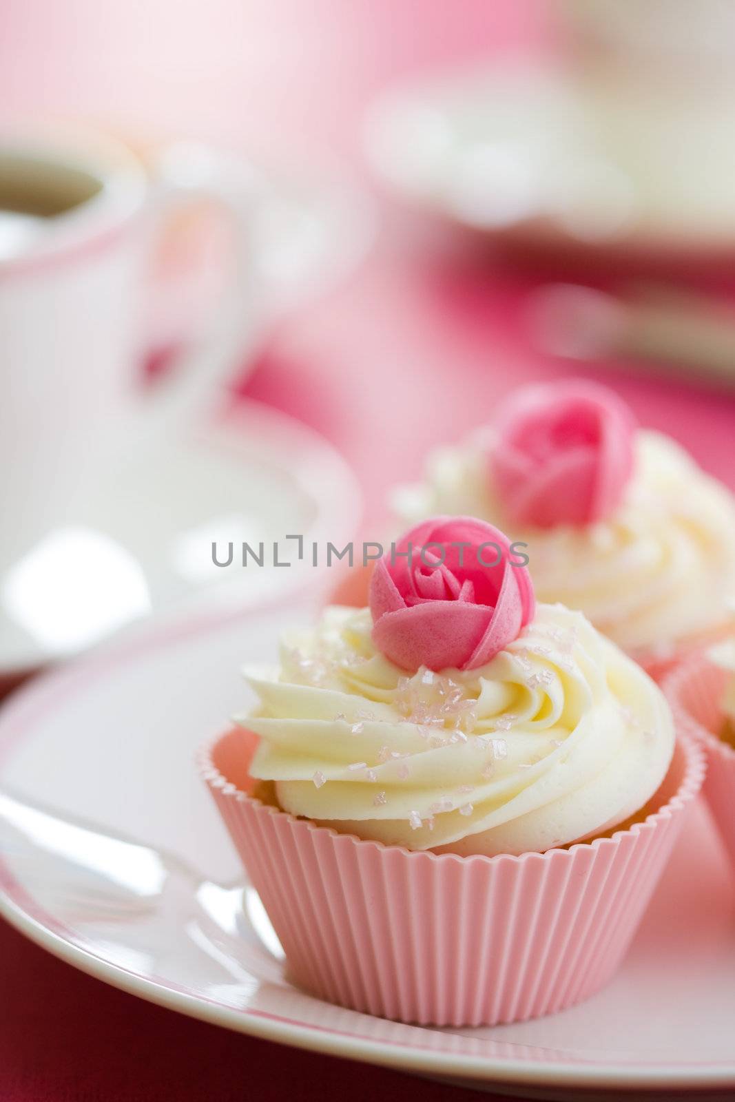 Pink rosebud cupcakes on a white plate