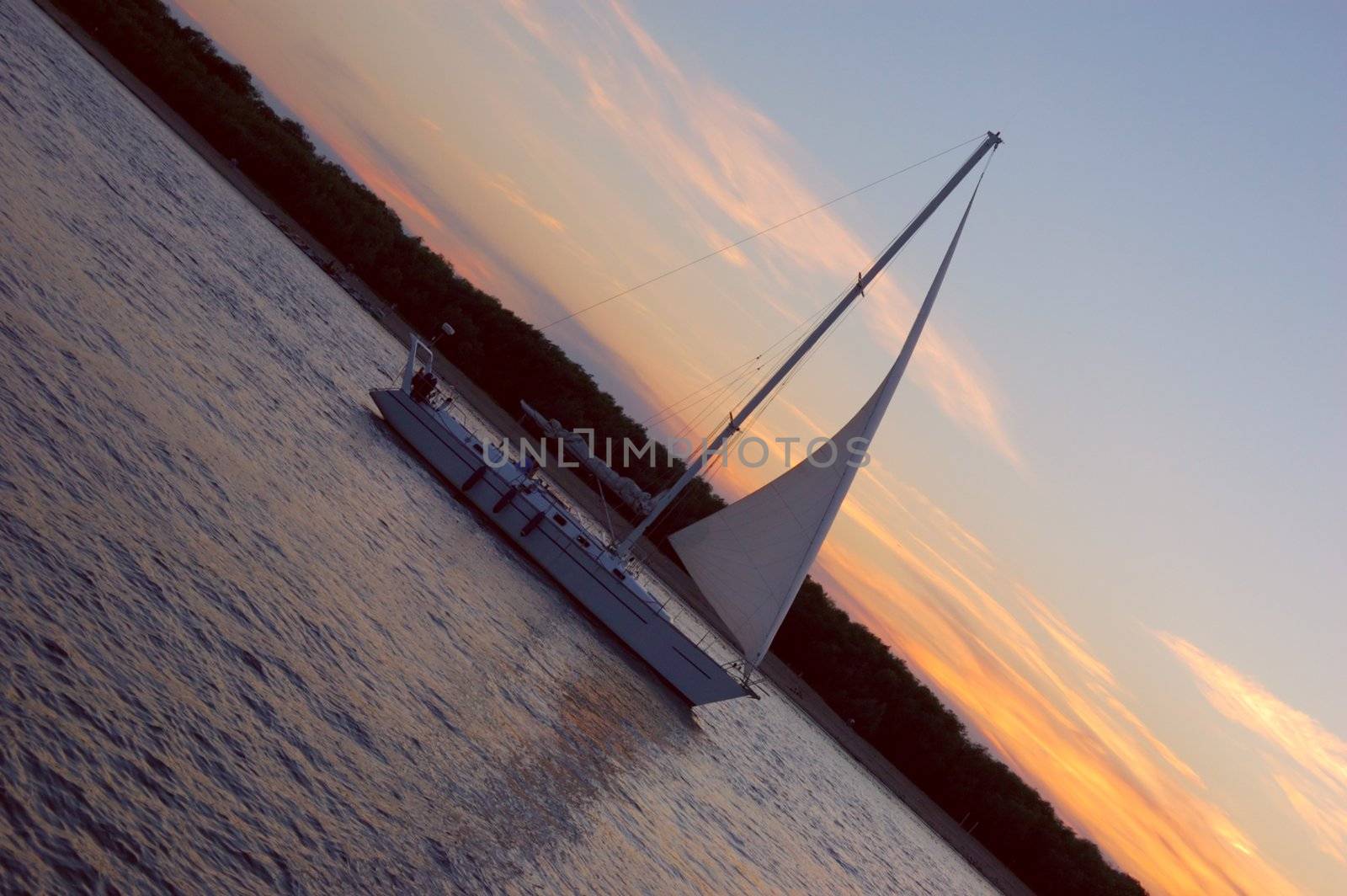 yacht sailing Volga-river against sunset