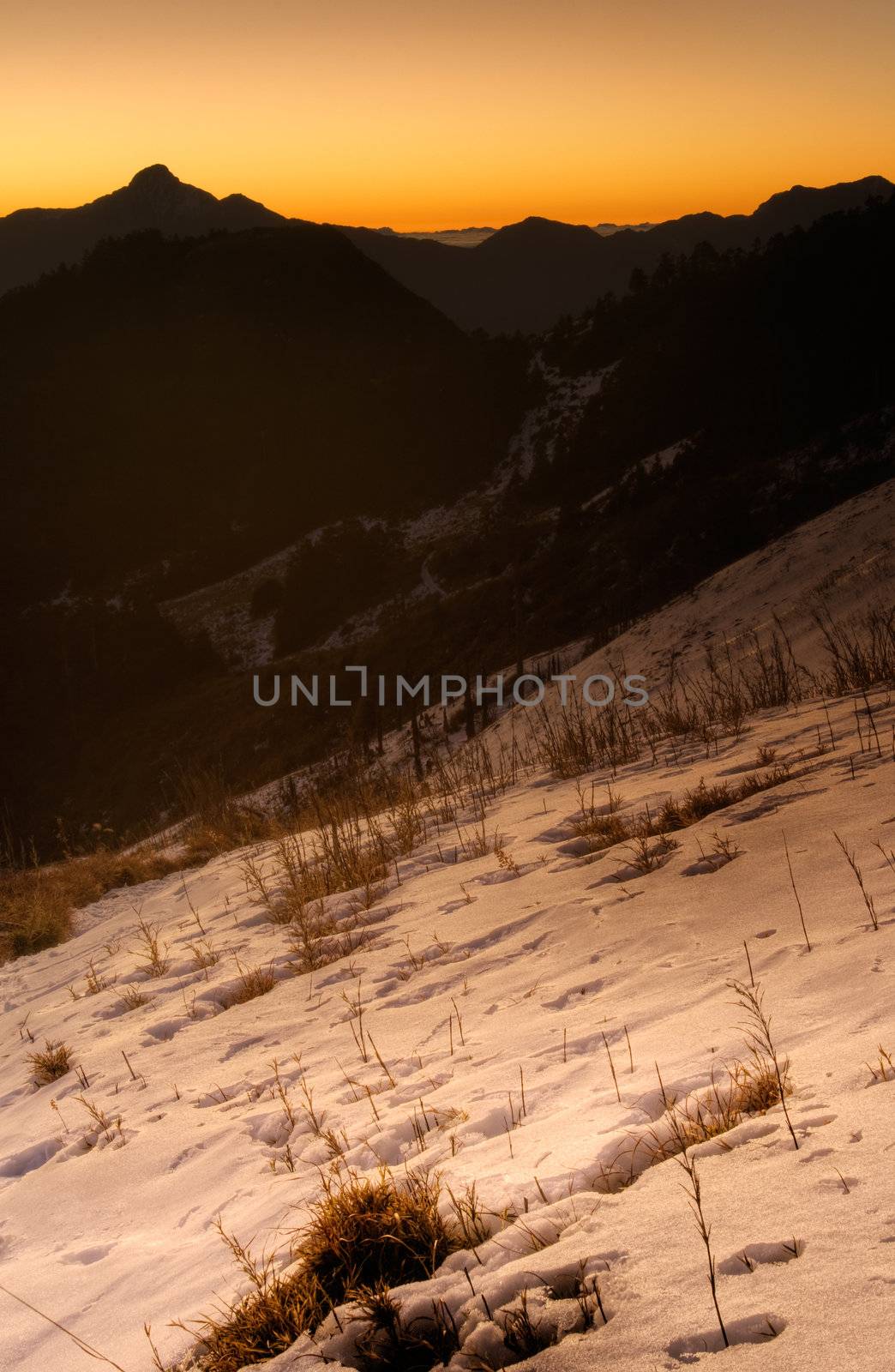 Sunrise mountain scenery with snow in winter morning.