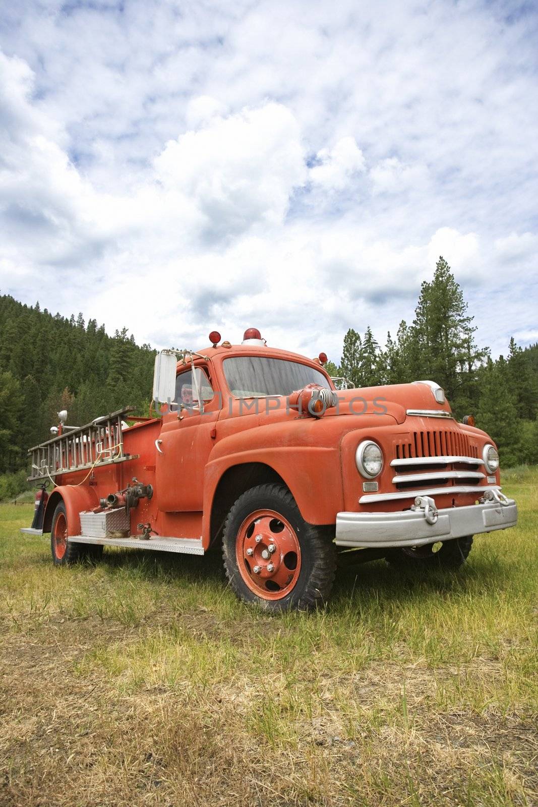 Low angle view of old fire truck in field.