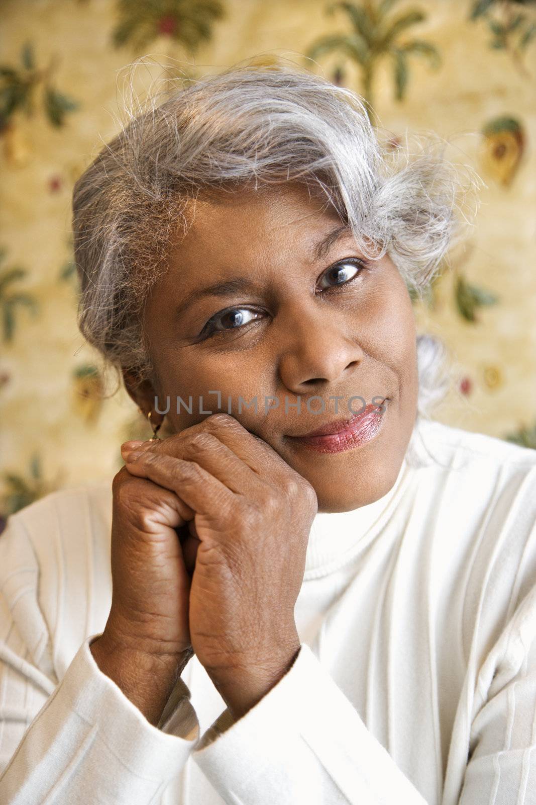 Portrait of mature African American woman looking at viewer.