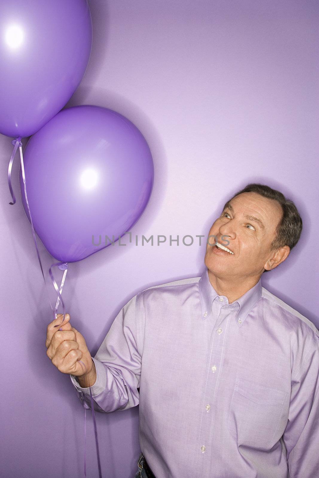 Man with balloons. by iofoto