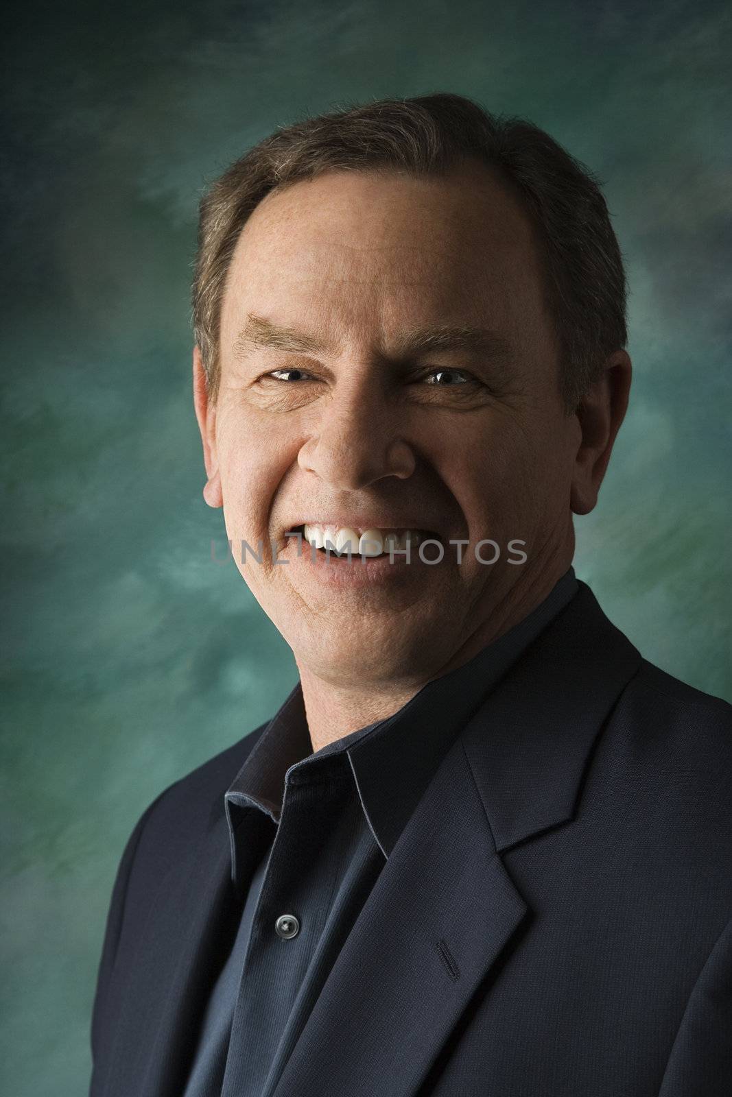 Middle-aged Caucasian man on studio background.