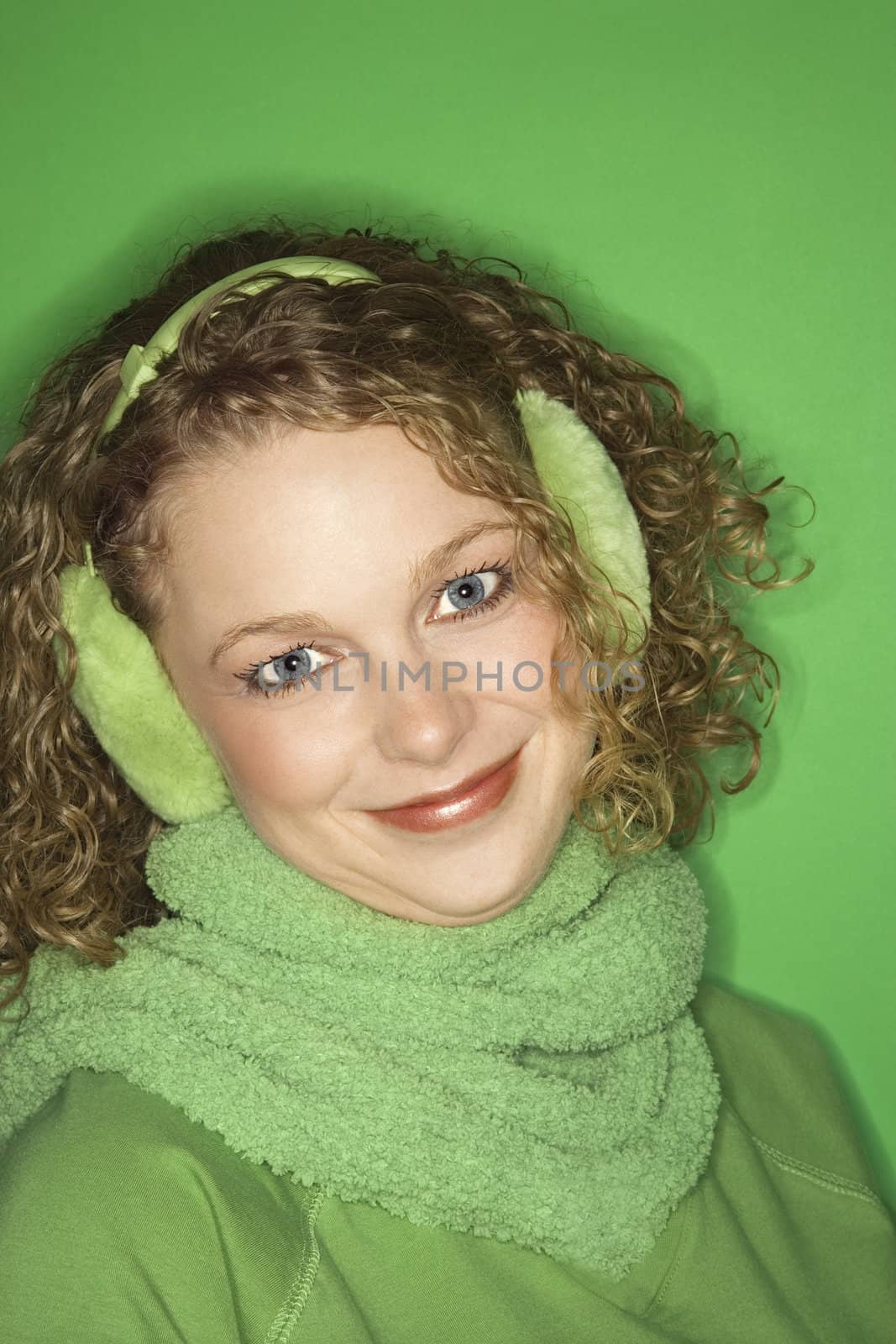 Woman wearing earmuffs. by iofoto