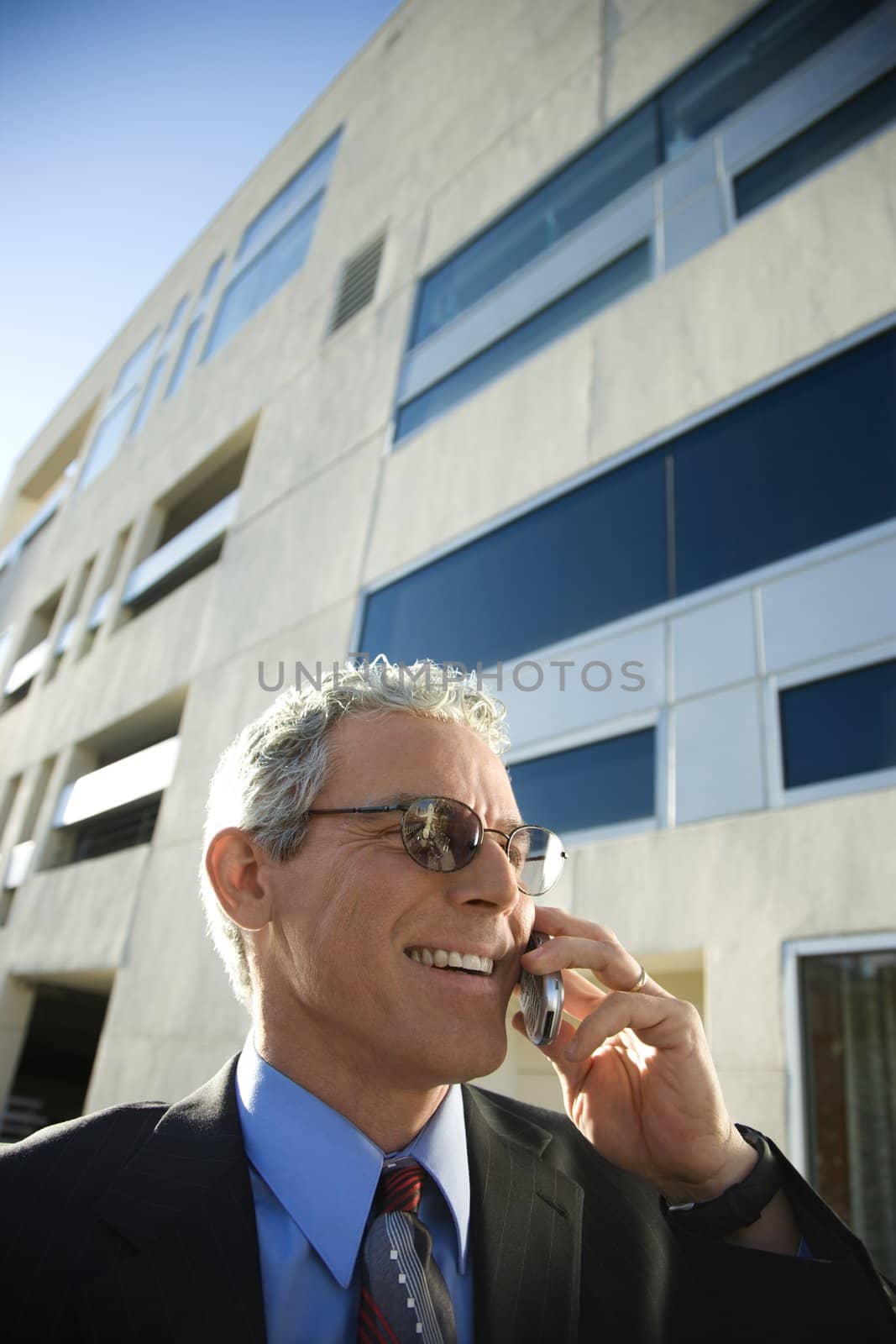 Man talking on cellphone. by iofoto