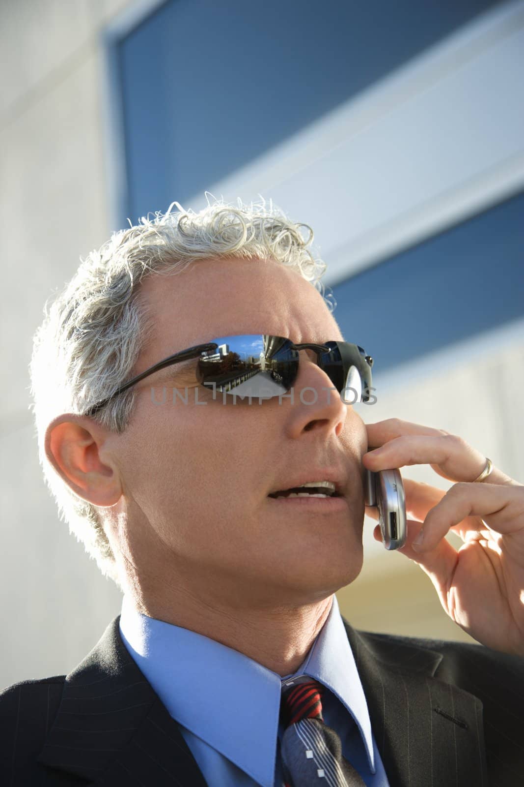 Businessman talking on cellphone. by iofoto