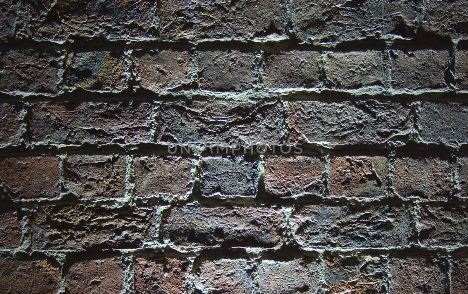 Very old (1854) brick wall with light shining from below