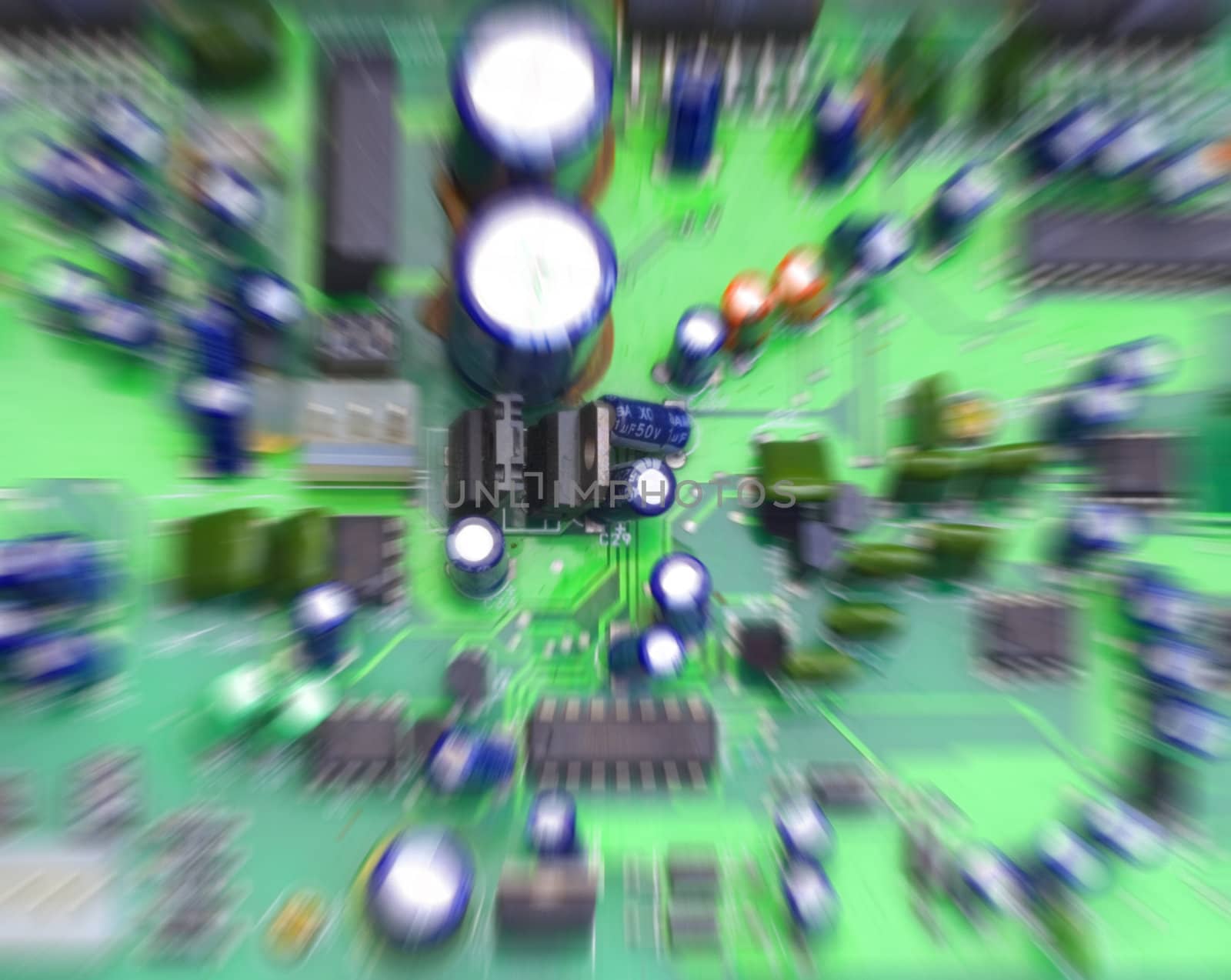 Colorful speaker/computer circuit board, focus on center with zoom blur.